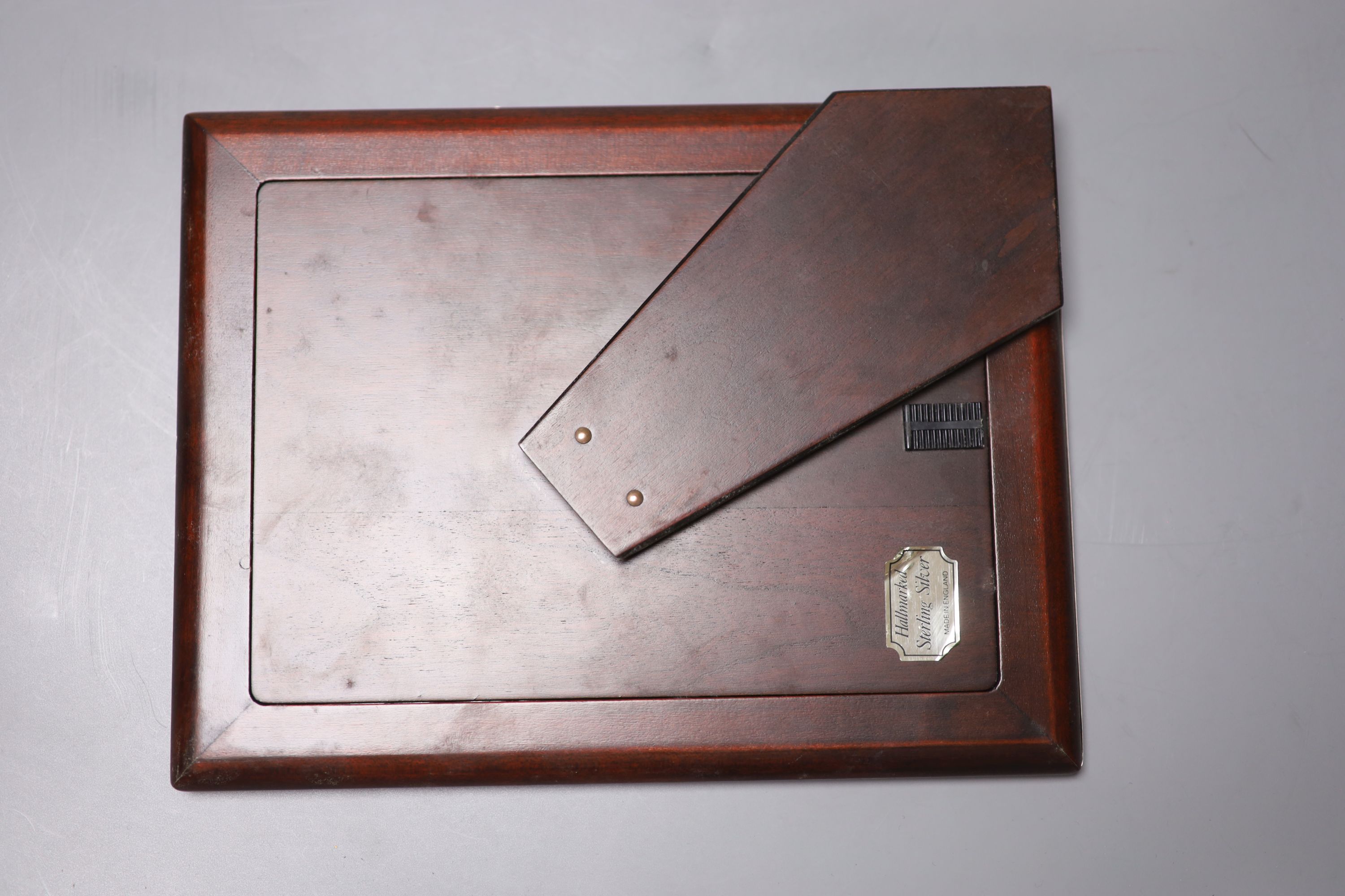 A modern silver mounted photograph frame, 22cm, and a silver mounted address book.